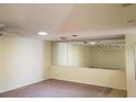 Spacious living room with a large mirrored wall at 1108 Apple Ter, Leesburg, FL 34748