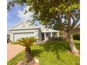 Charming single-story home featuring lush landscaping, a well-manicured lawn, and inviting curb appeal at 1180 Mesa Verde Ct, Clermont, FL 34711