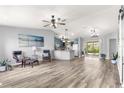 Open living space with modern vinyl floors, bright natural light and seamless kitchen access at 1224 Ballesteros Dr, The Villages, FL 32162