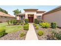 Inviting single-story home featuring mature landscaping and a walkway leading to the entrance at 12947 Se 97Th Terrace Rd, Summerfield, FL 34491