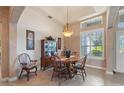 Elegant dining room with stylish chandelier, tray ceiling, and large window at 1351 Legendary Blvd, Clermont, FL 34711