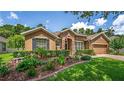 Charming single-story home with manicured lawn, stone accents, and inviting curb appeal at 1556 Blue Grass Blvd, Deland, FL 32724