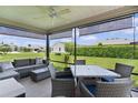 Screened patio offering comfortable seating and a table for outdoor dining at 1721 Germakian Ln, The Villages, FL 32163