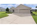 Exterior shot featuring a two-car garage and large driveway at 17355 Se 110Th Ter, Summerfield, FL 34491
