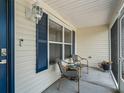 Cozy screened-in porch featuring comfortable seating and a view of the outdoors at 17824 Se 87Th Bourne Ave, The Villages, FL 32162