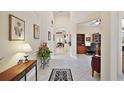 Inviting foyer featuring tile flooring, neutral walls, and an open floor plan at 2400 Pawtucket Pass, Mount Dora, FL 32757