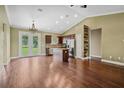 Spacious kitchen with wood floors, an island, and stainless steel appliances opens to living area at 2495 Se 75Th Blvd, Bushnell, FL 33513