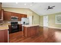 Open kitchen layout with stainless steel appliances, granite countertops, and a large central island at 2495 Se 75Th Blvd, Bushnell, FL 33513