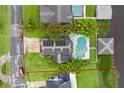 Aerial view of a home showcasing its private pool, boat dock, and proximity to the lake, with property line outline at 2610 Florence Dr, Kissimmee, FL 34744
