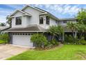 Charming two-story home with well-maintained lawn, lush landscaping, attached garage, and modern architectural design at 2610 Florence Dr, Kissimmee, FL 34744
