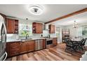 Modern kitchen with stainless steel appliances, granite countertops, and wood-look flooring at 27212 Orange Ave, Yalaha, FL 34797