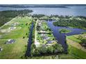 An aerial view of the property showcasing its location on a canal with access to a large lake at 29152 David Ct, Tavares, FL 32778