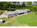 Aerial view showcasing the property's spacious yard, including a screen porch and covered parking area at 38314 Echols Rd, Leesburg, FL 34788
