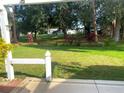 Serene backyard view with lush greenery and mature trees providing ample shade at 409 Westwood Dr, Leesburg, FL 34748