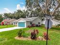 Landscaped yard with a well-maintained home, vibrant plantings, and corner street location at 4800 Tara View Rd, Leesburg, FL 34748