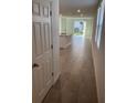 Bright hallway leading to an open-concept living space with modern tile flooring at 4957 Kaia Ave, Winter Haven, FL 33884