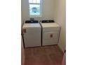 Practical laundry area with side-by-side washer and dryer, plus a window for natural light at 4957 Kaia Ave, Winter Haven, FL 33884