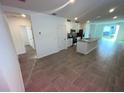 Spacious living area features tile floors, natural light, and seamless flow into the kitchen at 4957 Kaia Ave, Winter Haven, FL 33884