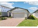 Charming one-story home featuring a brick driveway and two-car garage, beautiful landscaping at 4973 Kaia Ave, Winter Haven, FL 33884