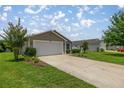 Charming single-story home with well-maintained lawn and an attached two-car garage at 5068 Ne 121St Ave, Oxford, FL 34484