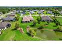 Expansive backyard featuring a pond and green space in a peaceful neighborhood setting at 6008 Apex Way, Lady Lake, FL 32159