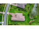 An aerial view of a well-maintained home with a brick driveway and manicured lawn at 6008 Apex Way, Lady Lake, FL 32159