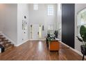 Grand entryway featuring high ceilings, wood-look floors, stylish staircase, and lots of natural light at 637 Neptune Dr, Groveland, FL 34736