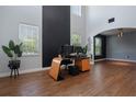 Open living space showcasing high ceilings, wood-look floors, modern black accents, and natural light at 637 Neptune Dr, Groveland, FL 34736