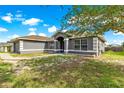 An attractive single-story house with well-kept lawn, showcasing a welcoming front entrance and attached two-car garage at 70 Locust Pass Run, Ocala, FL 34472
