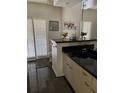 Bathroom featuring black countertops, a large mirror, and window with plantation shutters at 724 Rosemere Cir, Orlando, FL 32835