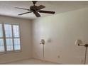 Spacious bedroom with plush carpet, a ceiling fan, and a large window with plantation shutters at 724 Rosemere Cir, Orlando, FL 32835