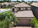 Beautiful home with a patterned tile roof and a brick driveway at 8800 Corcovado Dr, Kissimmee, FL 34747
