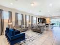 Bright living space with contemporary furnishings and tile flooring at 8800 Corcovado Dr, Kissimmee, FL 34747