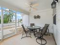 Cozy screened-in porch featuring a ceiling fan and comfortable seating, perfect for relaxing outdoors at 1199 Mathews Ln, The Villages, FL 32162
