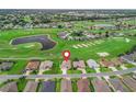 Aerial view of the home in a beautiful golf course community with mature trees, pond and sand traps at 12198 Se 176Th Loop, Summerfield, FL 34491