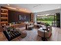 Modern living room with a fireplace, built-in shelving, sleek furniture, and a view of the backyard at 1237 Mercedes Pl, Orlando, FL 32804