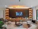 Modern living room featuring a fireplace, built-in shelving, sleek furniture, and lots of light at 1237 Mercedes Pl, Orlando, FL 32804