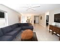 Bright living room with tile floors, ceiling fan, a comfortable sectional couch and view to dining area at 1325 Balboa Ct, The Villages, FL 32159