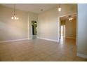 Inviting living room with tile floors, neutral walls, and arched entryways, creating a comfortable and open atmosphere at 1355 Misty Glen Ln, Clermont, FL 34711