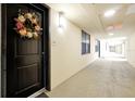 Hallway view outside unit #202 featuring a decorative wreath on the front door at 16300 County Road 455 # 202, Montverde, FL 34756