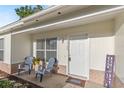 Cozy front porch with seating, decorative welcome mat, and tasteful decor at 1726 Tropical Ct, Tavares, FL 32778