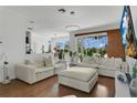 Spacious living room with modern lighting, comfortable seating, and view of outdoor space at 17300 Summer Sun Ct, Clermont, FL 34711