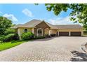 Beautiful single-Gathering home with a brick paver driveway and a spacious three-car garage at 18008 Victorian Dr, Clermont, FL 34715