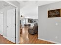 View of the dining and living room boasting wood floors and a Gathering art piece at 2336 Martins Run, Tavares, FL 32778