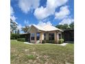 Lovely brick home with a screened porch surrounded by lush landscaping at 3147 Rambler Ave, St Cloud, FL 34772
