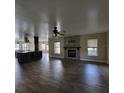Open-concept living space featuring a stone fireplace and wood-look flooring at 3147 Rambler Ave, St Cloud, FL 34772