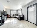 Cozy living room with neutral tones, comfortable seating, tile floor and a bright, airy feel at 326 N Lancelot Ave, Orlando, FL 32835