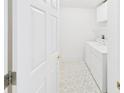 Bright laundry room featuring white washer and dryer set and unique patterned flooring for added style at 32701 Timberwood, Leesburg, FL 34748