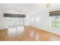Bright and airy living room with a large glass sliding door, ceiling fan, and stylish window treatments at 32701 Timberwood, Leesburg, FL 34748
