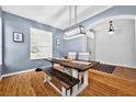 Bright dining room featuring a modern light fixture, and wooden dining table with bench seating at 33316 Irongate Dr, Leesburg, FL 34748
